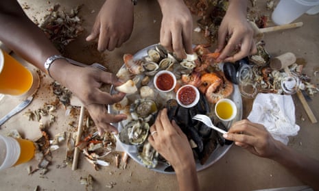 People sharing platter of shellfish