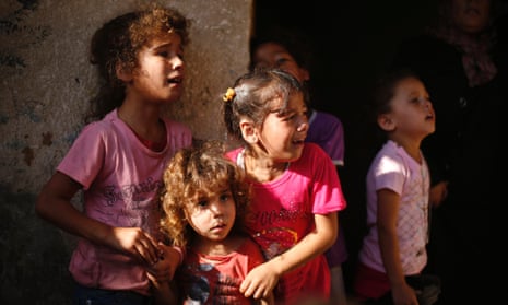 Relatives of four Palestinian children killed on a beach by Israeli bombardment mourn during the funeral in Gaza city.