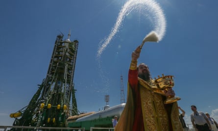 An Orthodox priest blesses the Russian Soyuz TMA-13M rocket booster on the launch pad at the Baikonur Cosmodrome, Kazakhstan, in May 2014.