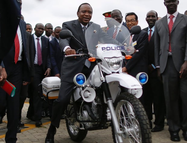Kenyan president Uhuru Kenyatta test-rides a police motorbike made by Toyota in Nairobi, Kenya, 16 July 2014.
