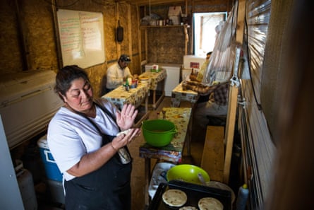 A woman makes tortillas in a make-shift restaurant, constructed of plywood and two-by-fours and attached to a motorhome in Watford City, near Williston.
