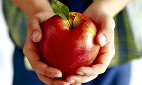 A boy holding an apple.