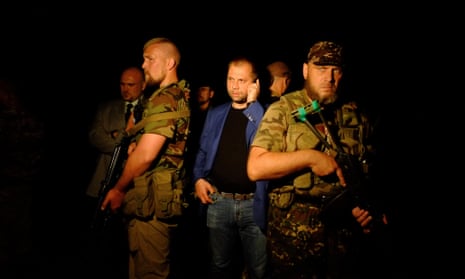 Self-proclaimed Prime Minister of the pro-Russian separatist "Donetsk People's Republic" Alexander Borodai (C) stands as he arrives on the site of the crash of a malaysian airliner carrying 298 people from Amsterdam to Kuala Lumpur, near the town of Shaktarsk, in rebel-held east Ukraine.