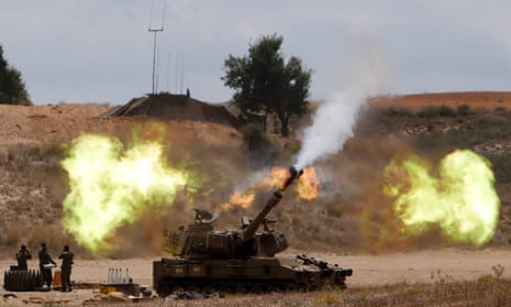 An Israeli mobile artillery unit fires towards the Gaza Strip.