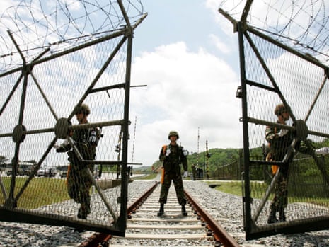 South Korean soldiers open the gate for the North Korea's train to pass near the demilitarized zone (DMZ) in 2007.