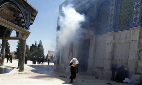 A palestinian girl runs away from exploding tear gas at the Dome of the Rock on the Temple Mount, or El Hareem el Sharif (The Noble Sanctuary) in Jerusalem after Friday prayers when Palestinians protested against Israeli attacks in Gaza.