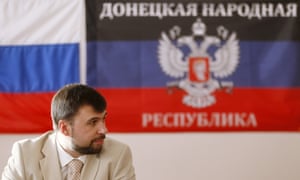 Denis Pushilin in front of a flag of the self-proclaimed Donetsk People's Republic in Donetsk.