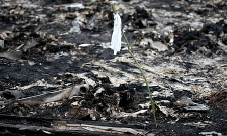 A white flag marks human remains at the site of the Malaysia Airlines plane crash in Ukraine