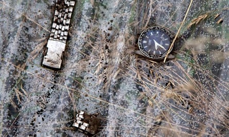 A broken watch lies on a plastic cover at the site of the Malaysia Airlines crash