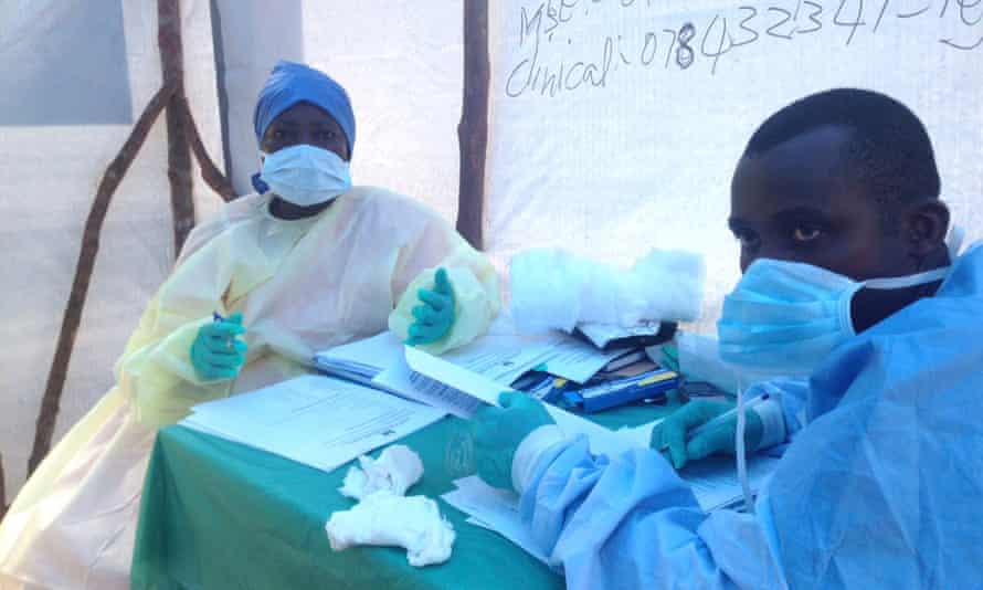 Government health workers are during the administration of blood tests for the Ebola virus in Kenema, Sierra Leone.