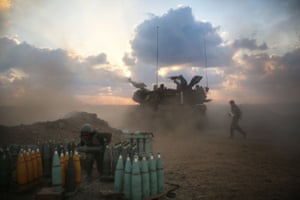 Israeli soldiers from the 155mm artillery cannons unit fire towards the Gaza Strip.