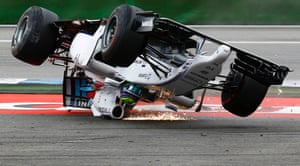 Sparks fly as Felipe Massa of Brazil overturns his car on the first corner of the German Grand Prix at Hockenheim.