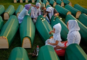 Women mourn at a relative's coffin before a funeral in Kozarac for bodies found in a mass grave believed to be the largest from Bosnia's 1992-95 war.