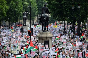 Tens of thousands of pro-Palestinian demonstrators march up Whitehall towards the Israeli embassy during a protest in London.