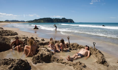 Tourists relax in the thermal pools of Hot Water Beach
