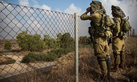 Israeli soldiers on a hill overlooking the Israeli-Gaza border