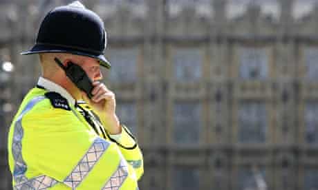 Police officer in front of Palace of Westminster