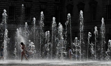 Visitors to Somerset House run through the courtyard fountains in central London