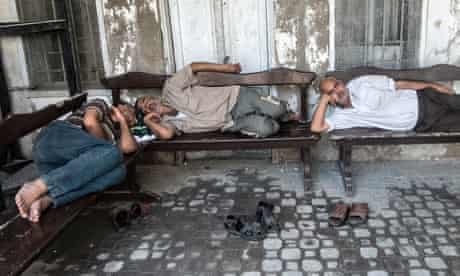 Exhausted Gazans outside the Greek Orthodox Church