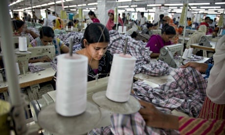A worker sews plaid shirts on the production line of the Fashion Enterprise garment factory. 