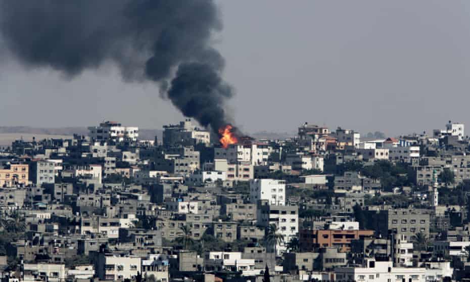 Fire and smoke rises from burning buildings hit by an Israeli air strike in the Shajaiyeh neighborhood of Gaza City.