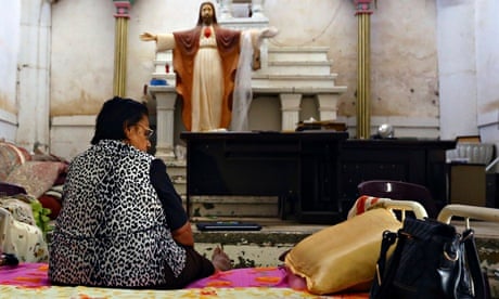 An Iraqi Christian woman fleeing the violence in the Iraqi city of Mosul
