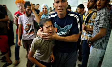 A Palestinian boy cries as compound is evacuated