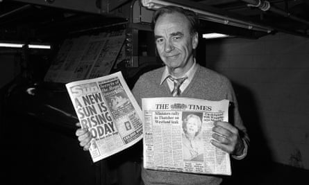 Rupert Murdoch with copies of the Sun and the Times papers at his new print works in Wapping in 1986