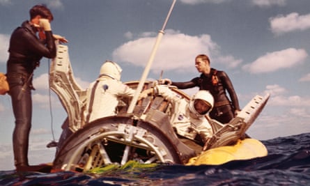 astronauts tom Stafford (L) and Wally Schirra pop out of their spacecraft after splashdown in the Atlantic December 16th, following historic rendezvous with Gemini 7