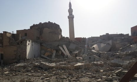 People inspect the destroyed mosque of the prophet Jirjis in Mosul on Sunday.