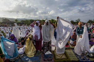 Yogyakarta, Indonesia - Women attend Eid Al-Fitr prayer on the 'sea of sands' at Parangkusumo beach.
