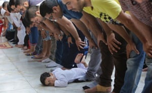 Cairo, Egypt: A child plays during prayer at the Al-Azhar mosque.