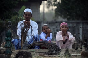 Narathiwat, Thailand: Muslims pray at a cemetery on the first day of Eid al-Fitr celebrations.