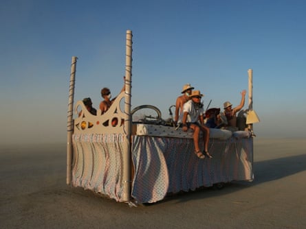 People ride around on an art car at the Burning Man Festival.