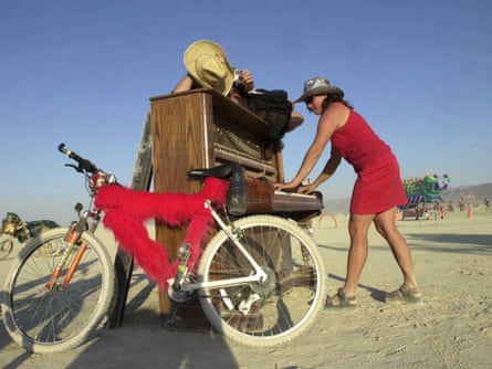 Participants at the annual Burning Man Festival play an off key "Fur Elise"  at one of the art installations.