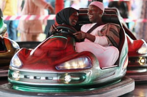 People ride on Bumper cars during an Eid celebration in Burgess Park in London, England.