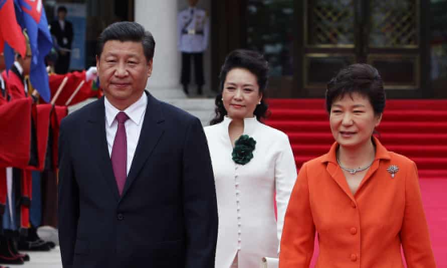 Chinese President Xi Jinping, his wife Peng Liyuan and South Korean President Park Geun-Hye walk towards a guard of honour during a welcoming ceremony held at the presidential Blue House on 3 July, 2014 in Seoul.