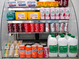 A cabinet containing felt milk containers and fizzy drinks