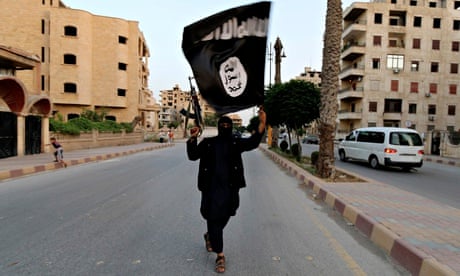 A militant waves a black Isis flag in Iraq