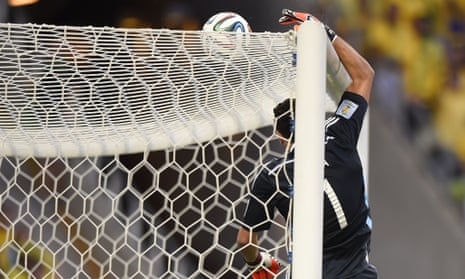 Colombia's goalkeeper David Ospina tips the ball over as Brazil exert more pressure on his goal.