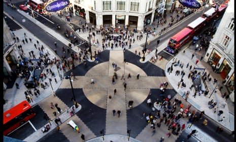 Pedestrians cross the new diagonal road crossing at Oxford Circus in London. The design of the new pedestrian crossing was inspired by the Shibuya crossing in Tokyo and allows pedestrians to cross diagonally.