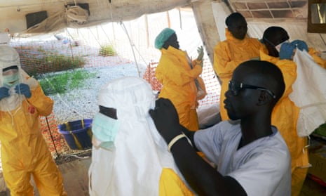 Members of work in an isolation ward in a hospital in Conakry, where people infected with the Ebola virus are being treated