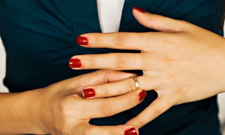 Woman taking off wedding ring