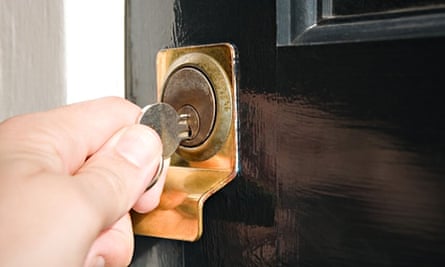 Person putting key in keyhole