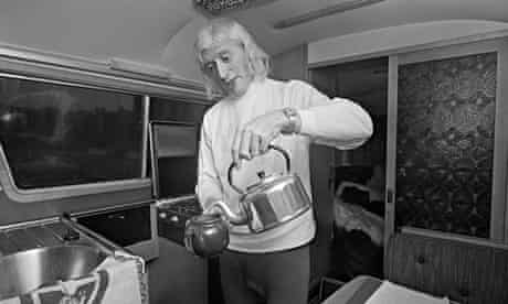English DJ and television presenter Jimmy Savile making himself a pot of tea in his motor home, 31 D