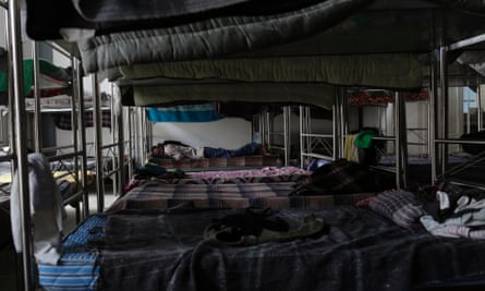 A migrant sleeps on a bunk bed inside a Catholic migrant shelter in San Luis Potosi.
