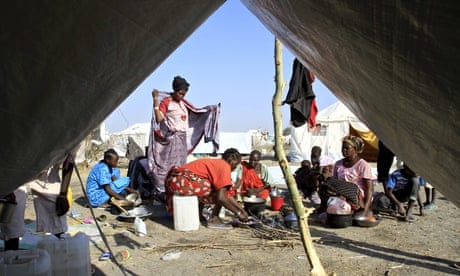 South Sudanese refugees cook on an open