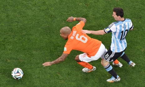 Netherlands' midfielder Nigel de Jong tussles with Argentina's forward and captain Lionel Messi.