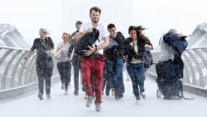 People caught in torrential rain while walking along Millennium Bridge in London.