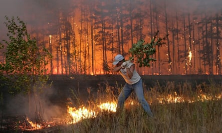 A Russian man tries to stop fire near village Dolginino on August 4, 2010. Russia's worst heatwave for decades shows no sign of relenting, officials warned as firefighters battled hundreds of wildfires in a national disaster that has claimed at least 40 lives.